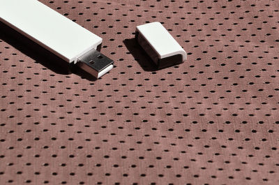 High angle view of usb stick on fabric