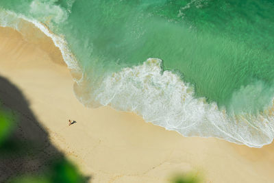 Aerial view of woman standing at seashore