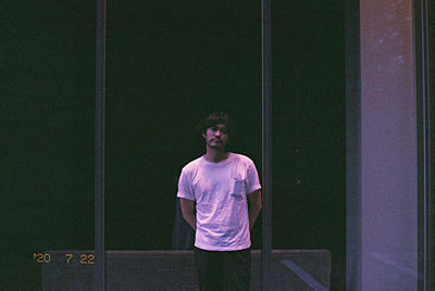 Portrait of young man looking away outdoors