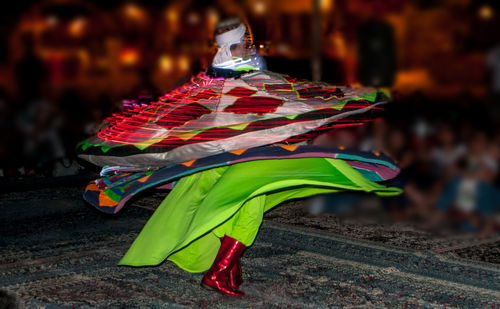 Close-up of woman with multi colored umbrella