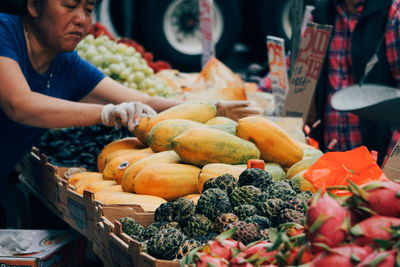 Midsection of man for sale at market stall