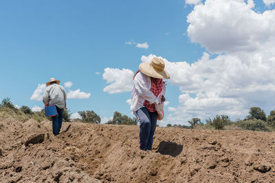 Rear view of woman standing on field