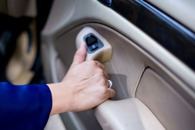 Close-up of woman holding car door