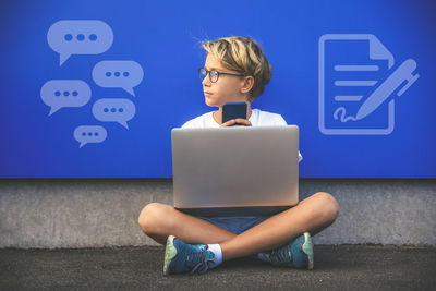 Boy communicate with laptop and smartphone. analog versus digital technology. new tech concept.