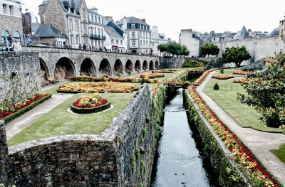 Arch building beside canal in city