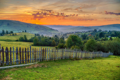 Scenic view of landscape against orange sky