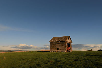 Built structure on field against sky