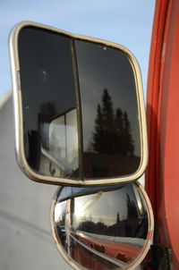 Reflection of trees on car side-view mirrors