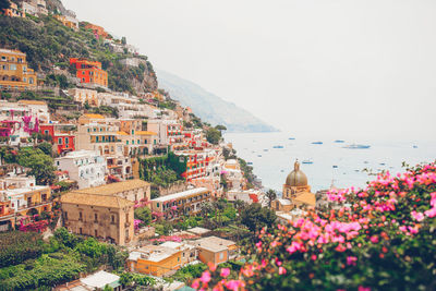 Scenic view of sea and buildings against clear sky