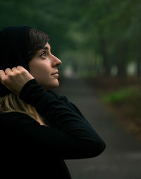 Portrait of young man looking away outdoors