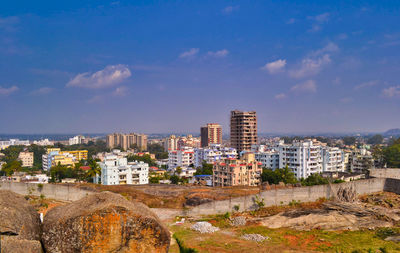 High angle view of buildings against blue sky