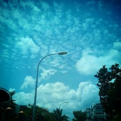 Low angle view of building against cloudy sky