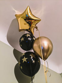 Low angle view of balloons against wall