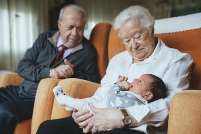 Great grandparents taking care of great granddaughter at home