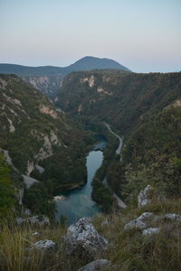 Scenic view of lake amidst mountains against sky