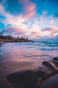 Scenic view of beach against sky during sunset