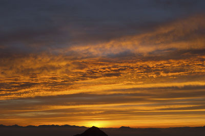 Scenic view of dramatic sky during sunset