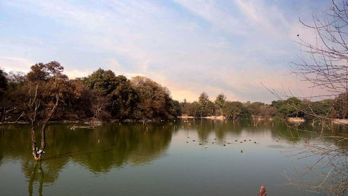 Scenic view of lake against sky at sunset