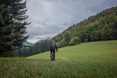 Man riding bicycle on field