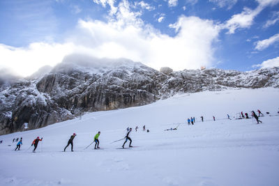 Group of people skiing on snow landscape