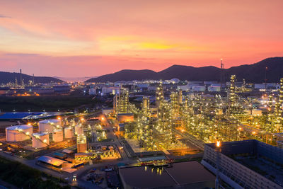 High angle view of illuminated buildings against sky at sunset