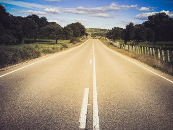 Surface level of country road against sky