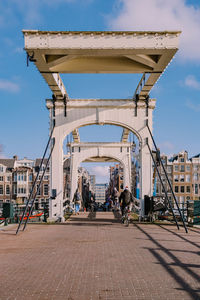 People walking on bridge in city