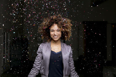 Confetti falling on laughing woman