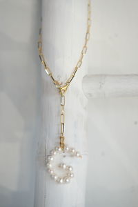 Close-up of chain hanging against white background