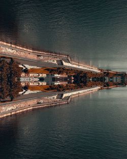 High angle view of bridge over sea against buildings