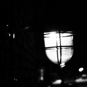 Close-up of illuminated lamp against sky