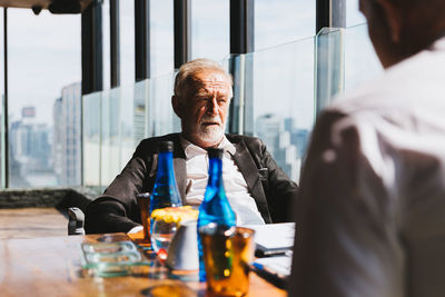 Businessman and colleague sitting at table