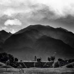 Scenic view of mountains against cloudy sky