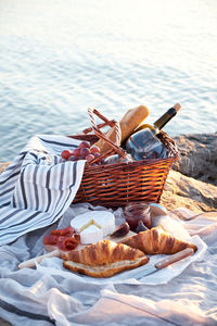 High angle view of food in basket by lake