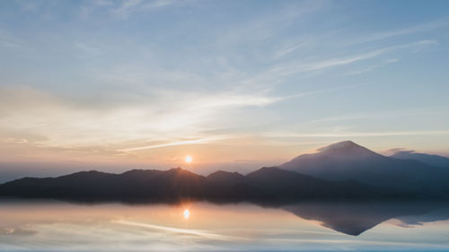 Scenic view of silhouette mountains against sky during sunset
