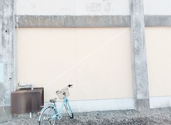 Bicycle parked by wall