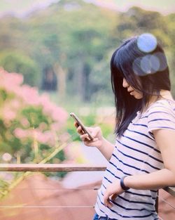 Side view of woman using smart phone