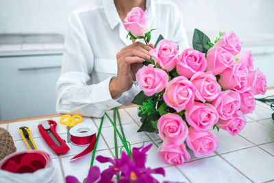 Midsection of doctor holding bouquet