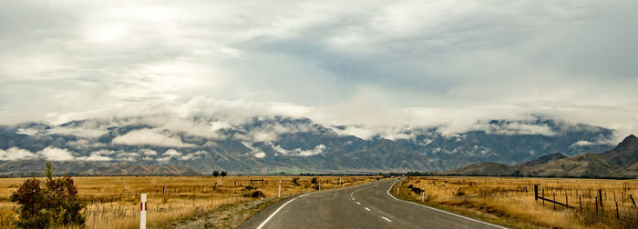 Empty road along countryside landscape