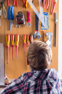 Rear view of boy standing with text