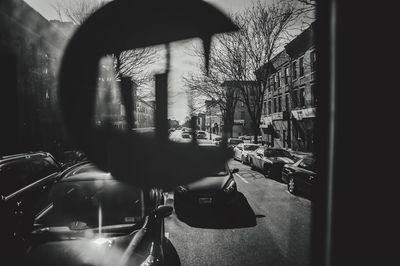 Cars on street against buildings in city