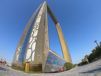 Low angle view of modern building against blue sky