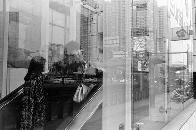 Digital composite image of street and buildings seen through glass window