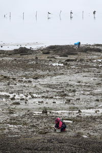 People sitting on land during winter