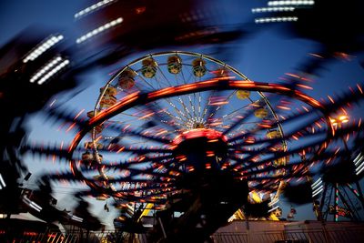 Blurred motion of amusement park ride at night