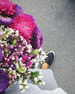 Low section of woman wearing bouquet