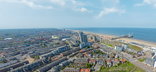 High angle view of cityscape by sea against sky