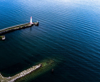 High angle view of lighthouse by sea