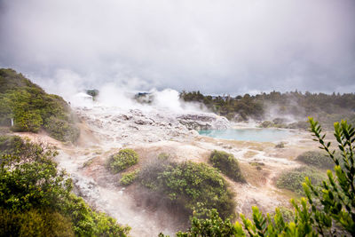 Scenic view of waterfall against sky