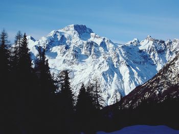 Low angle view of snowcapped mountains against sky